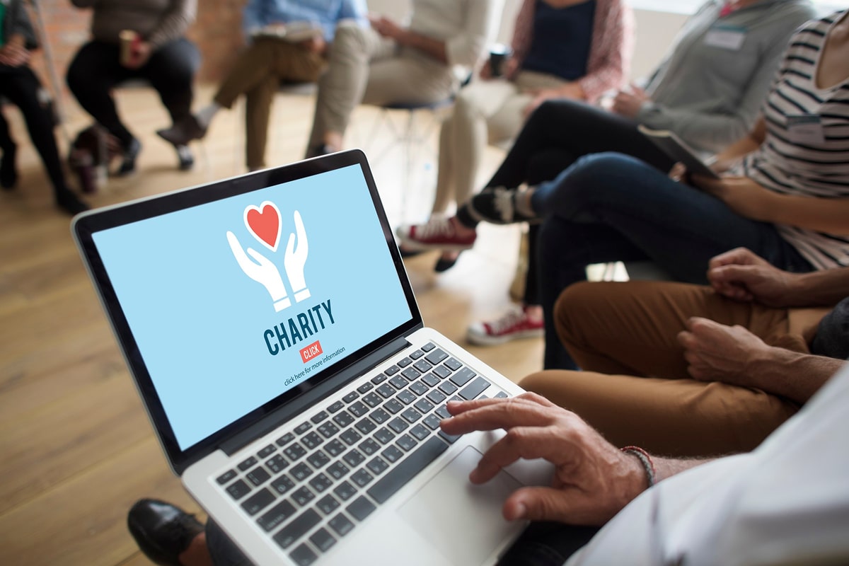 Person looking at a charity website on their laptop