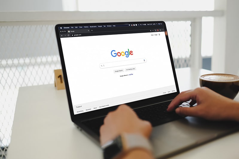 Person on laptop using Google