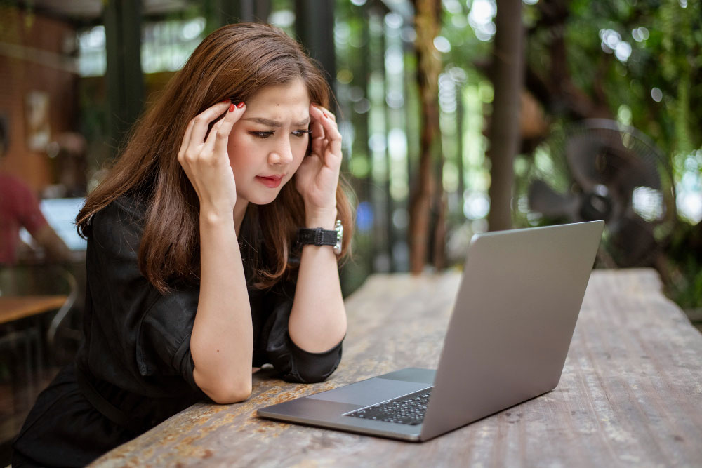 woman stressed looking at laptop