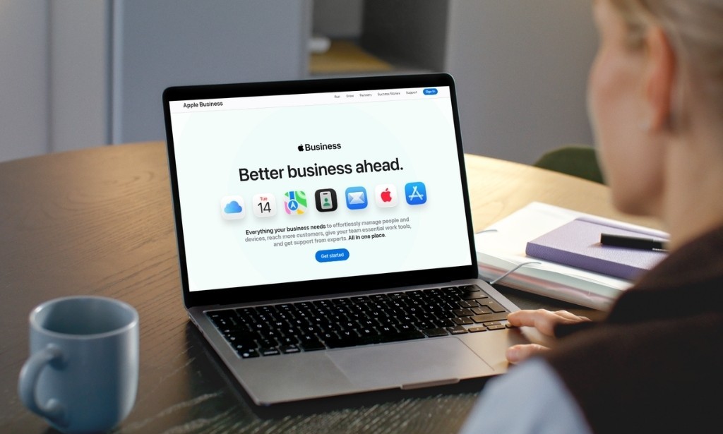 Person viewing the Apple Business website on a laptop at a desk.