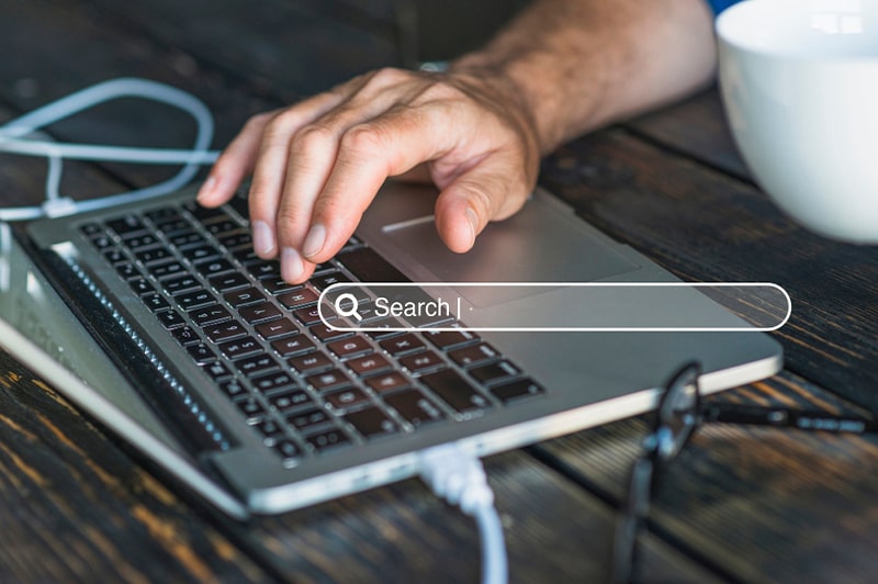 Person searching on laptop