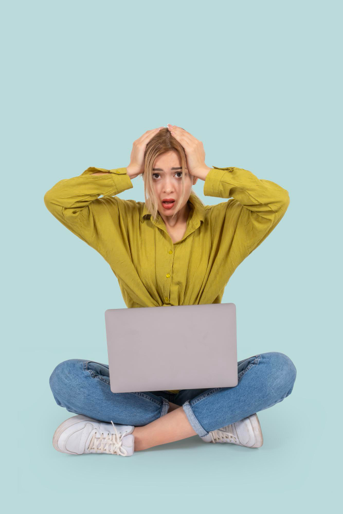 woman worried sitting at laptop