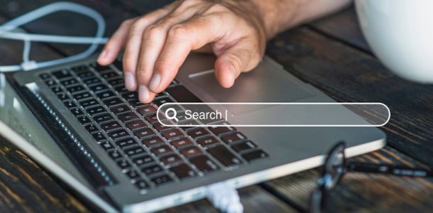 Person searching on laptop