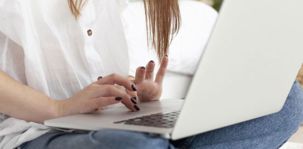 Woman working with her laptop her lap