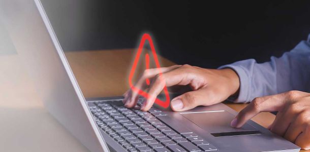 Person typing in a  laptop with a red arrow screen abstract graphic