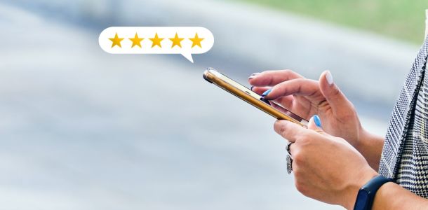 Person on their phone leaving a 5 star Google review