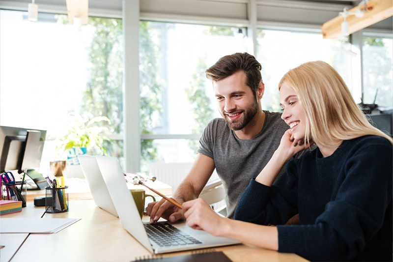 Man and woman in office working on a website design