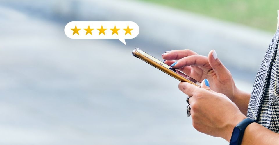 Person on their phone leaving a 5 star Google review
