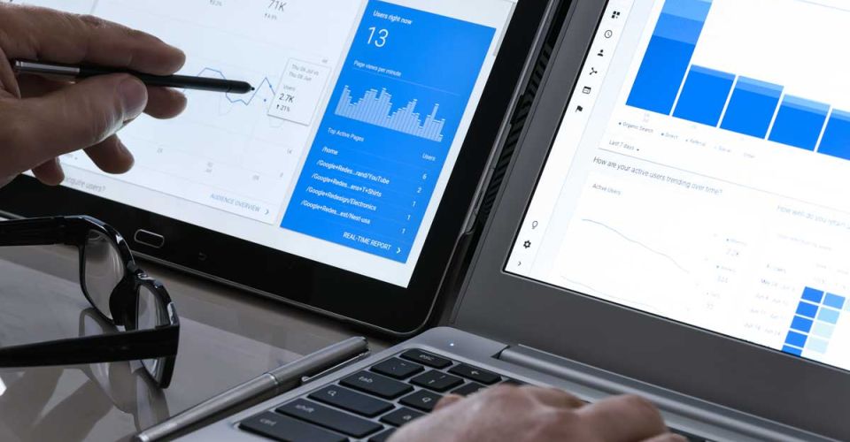 laptop and touchscreen displaying website traffic analytics