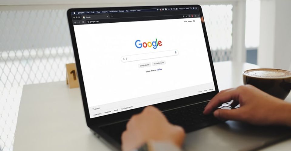 Person on laptop using Google