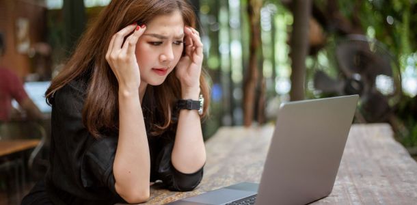 woman stressed looking at laptop